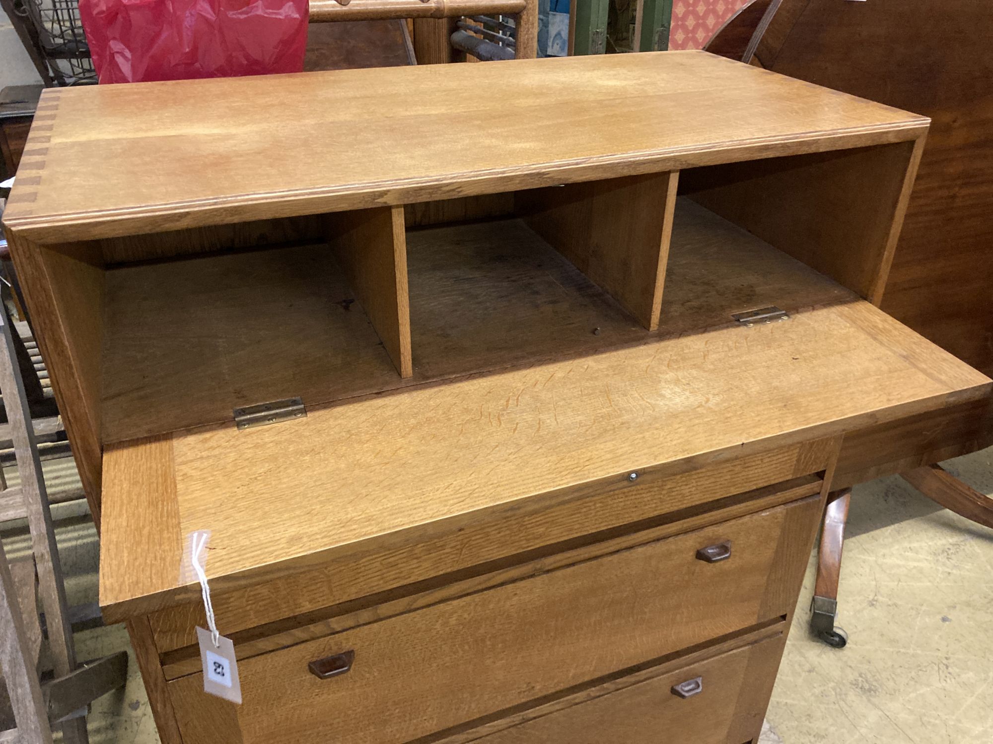 A mid century Cotswold School four section oak drop leaf cabinet, width 91cm, depth 46cm, height 111cm